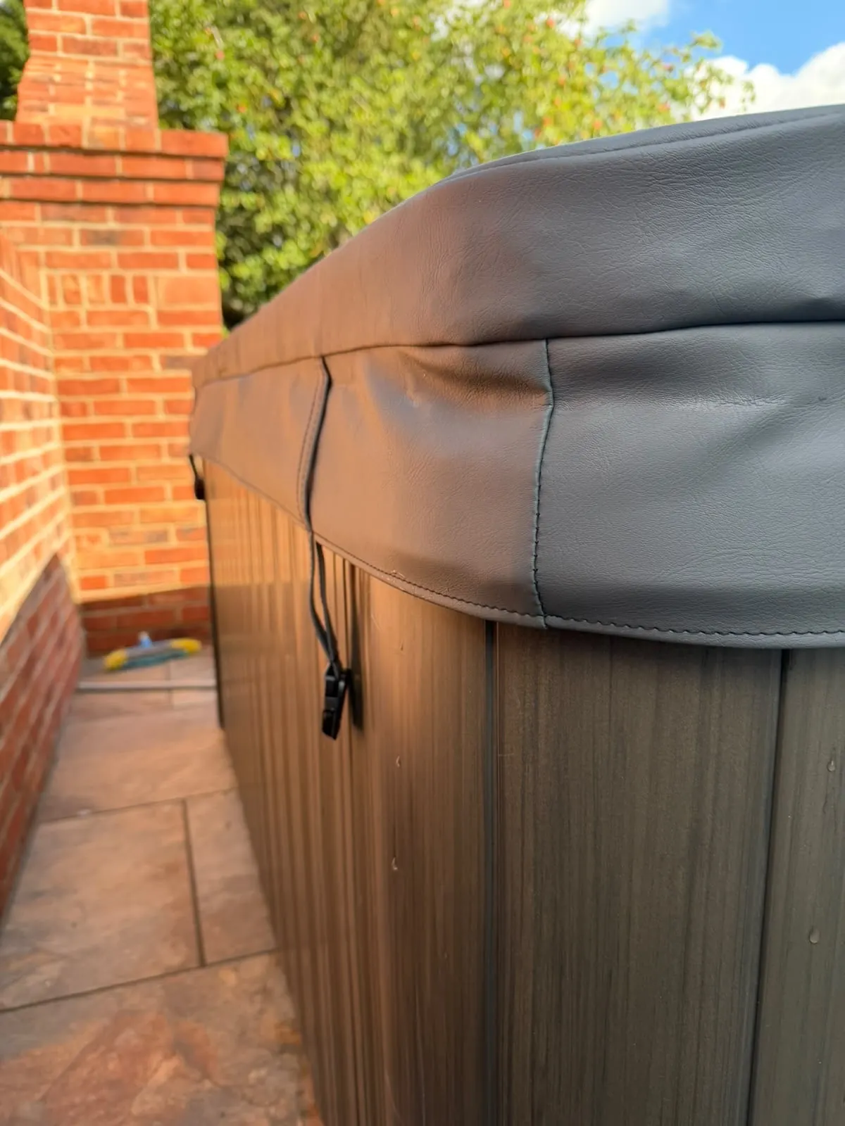 Hinge and strap detail on a new marine vinyl hot tub cover