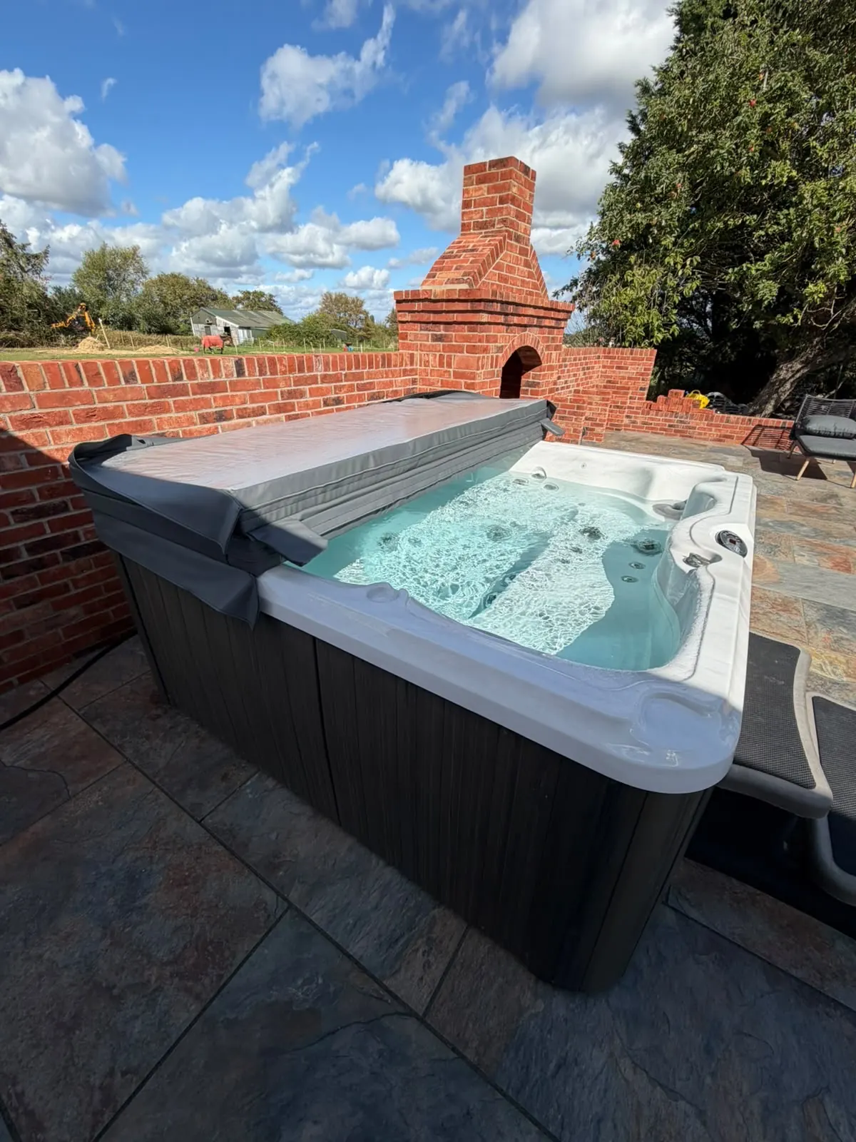Hot tub cover folded back with the jets running