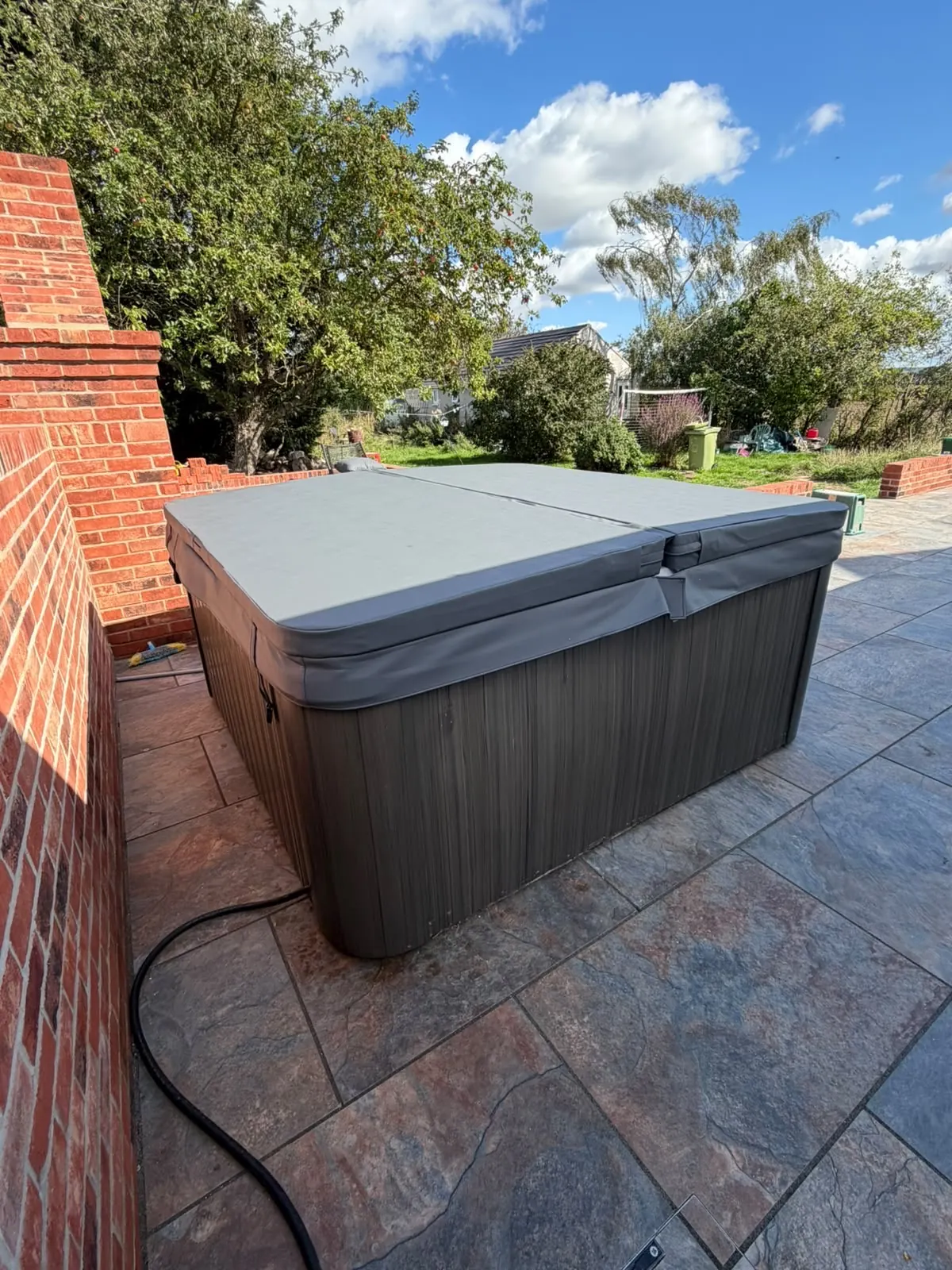 New hot tub cover fitted to a hot tub on a patio